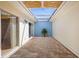 The enclosed patio features brick floors, a blue accent wall, and skylights at 10467 Larchmont N Pl, Pinellas Park, FL 33782