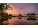 Wide lake view with the fountain and colorful sunset sky reflected in the water at 10467 Larchmont N Pl, Pinellas Park, FL 33782