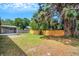 A spacious and well-maintained backyard featuring a new fence and a partially shaded screened lanai at 105 Lotus Cir, Safety Harbor, FL 34695