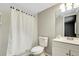 Cozy bathroom featuring a toilet, sink, mirror and shower with white tiles at 105 Lotus Cir, Safety Harbor, FL 34695