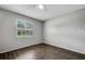 Bright bedroom with hardwood floors, gray walls, and a window with white blinds at 105 Lotus Cir, Safety Harbor, FL 34695