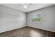 Well-lit room with wood flooring and a window covered in blinds at 105 Lotus Cir, Safety Harbor, FL 34695
