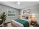 Staged bedroom featuring a queen bed, nightstands, and a large window with white blinds at 105 Lotus Cir, Safety Harbor, FL 34695