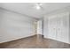 Bedroom featuring hardwood floors, a ceiling fan, and an ensuite bathroom at 105 Lotus Cir, Safety Harbor, FL 34695