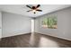 Empty bedroom features luxury vinyl flooring, neutral paint, and a large window at 105 Lotus Cir, Safety Harbor, FL 34695