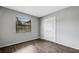 Bedroom with sleek wood floors, a window for natural light, and a closet for storage at 105 Lotus Cir, Safety Harbor, FL 34695