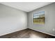 Bright bedroom featuring wood flooring, a large window, and neutral walls at 105 Lotus Cir, Safety Harbor, FL 34695
