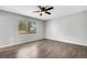 Empty bedroom with luxury vinyl flooring, neutral walls, and a window letting in natural light at 105 Lotus Cir, Safety Harbor, FL 34695