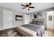 Staged bedroom featuring a king bed, luxury vinyl flooring, and an ensuite bathroom at 105 Lotus Cir, Safety Harbor, FL 34695