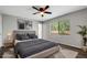 Comfortable bedroom featuring a ceiling fan, soft rug, and ample natural light from the large window at 105 Lotus Cir, Safety Harbor, FL 34695