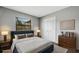 Staged bedroom with sleek wood floors, a window for natural light, and a closet for storage at 105 Lotus Cir, Safety Harbor, FL 34695
