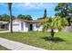 Inviting single-story home featuring a lush front lawn and an attached garage in a peaceful residential neighborhood at 105 Lotus Cir, Safety Harbor, FL 34695