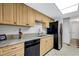 Modern kitchen featuring granite countertops, stainless steel appliances, and tile flooring at 105 Lotus Cir, Safety Harbor, FL 34695
