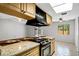 Modern kitchen with granite countertops, stainless steel appliances, and a large window offering natural light at 105 Lotus Cir, Safety Harbor, FL 34695
