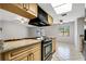 Bright kitchen with granite countertops, stainless steel appliances, and a view of the backyard through a window at 105 Lotus Cir, Safety Harbor, FL 34695