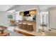 Staged kitchen with granite countertops, white tile floors, and dining area with seating at 105 Lotus Cir, Safety Harbor, FL 34695