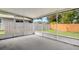 Screened lanai area features a concrete floor and views of the fenced yard and lush landscaping at 105 Lotus Cir, Safety Harbor, FL 34695