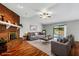 Staged living room features brick fireplace, neutral walls, and access to an enclosed outdoor patio, perfect for entertaining at 105 Lotus Cir, Safety Harbor, FL 34695