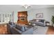 Bright, staged living room boasts hardwood floors, a brick fireplace, and contemporary furniture, ready to welcome you home at 105 Lotus Cir, Safety Harbor, FL 34695