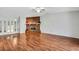 Spacious living room with vaulted ceiling, beautiful wood floors, and a cozy brick fireplace ready for your personal touch at 105 Lotus Cir, Safety Harbor, FL 34695