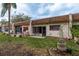 Charming patio with a seating area and lush landscaping, perfect for relaxation at 1273 Mission Cir, Clearwater, FL 33759
