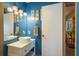 Stylish bathroom featuring a vessel sink, unique lighting fixtures, and coastal-themed decor for a relaxing atmosphere at 1273 Mission Cir, Clearwater, FL 33759