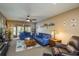 Comfortable living room with plush blue sofas, ceiling fan, and cozy decor at 1273 Mission Cir, Clearwater, FL 33759