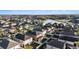 Overhead view showcasing the neighborhood with fenced yards near a pond and wooded area at 1555 Tallulah Ter, Wesley Chapel, FL 33543