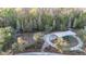 Aerial view of the community playground with swings and slides, surrounded by wooded area at 1555 Tallulah Ter, Wesley Chapel, FL 33543