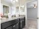 Bathroom featuring granite vanity, dual mirrors, and pendant lighting at 1598 Tallulah Ter, Wesley Chapel, FL 33543