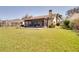 Large backyard with a screened-in lanai, offering ample space for outdoor activities at 1731 Elk Spring Dr, Brandon, FL 33511