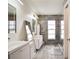 Sleek bathroom showcasing double sinks, modern fixtures, and a stylish glass-enclosed shower at 1731 Elk Spring Dr, Brandon, FL 33511