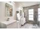 Modern bathroom featuring dual vanities, sleek tile, and a glass-enclosed shower, offering a spa-like experience at 1731 Elk Spring Dr, Brandon, FL 33511