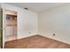 This empty bedroom has hardwood floors and an open door leading to the laundry room with tile floors at 1731 Elk Spring Dr, Brandon, FL 33511