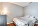 This is a furnished bedroom with gray walls, wood floors and a comfortable bed with floral bedding at 1731 Elk Spring Dr, Brandon, FL 33511