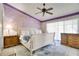 The main bedroom has purple accent walls, ceiling fan, and lots of natural light, creating a cozy retreat at 1731 Elk Spring Dr, Brandon, FL 33511