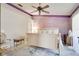 The main bedroom has purple accent walls, ceiling fan, and lots of natural light, creating a cozy retreat at 1731 Elk Spring Dr, Brandon, FL 33511