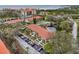 Aerial view showcases the building's tile roof, lush landscaping, and proximity to the bay at 1800 Mariner Dr # 9, Tarpon Springs, FL 34689