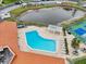 Get an aerial view of the inviting pool, pond, and tennis courts at 1800 Mariner Dr # 9, Tarpon Springs, FL 34689