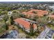 Aerial view of residential community with well-maintained landscaping, tile roofs, and nearby water features at 1800 Mariner Dr # 9, Tarpon Springs, FL 34689