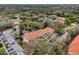 Aerial view of residential community surrounded by mature trees, ponds, and manicured lawns at 1800 Mariner Dr # 9, Tarpon Springs, FL 34689