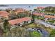 Aerial view of a residential community featuring lush landscaping, waterways, and nearby marina at 1800 Mariner Dr # 9, Tarpon Springs, FL 34689