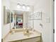 Well-maintained bathroom with a single vanity, ample lighting, and easy access to the bedroom at 1800 Mariner Dr # 9, Tarpon Springs, FL 34689