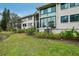 Beautifully landscaped condo building exterior featuring lush greenery and modern architectural design at 1800 Mariner Dr # 9, Tarpon Springs, FL 34689