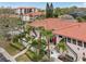 Exterior view of condos featuring well-manicured landscaping and private patios with outdoor seating at 1800 Mariner Dr # 9, Tarpon Springs, FL 34689