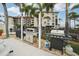 Outdoor grilling area featuring multiple high-quality gas grills for community gatherings with views of the condo buildings at 1800 Mariner Dr # 9, Tarpon Springs, FL 34689