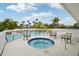Relax in this inviting hot tub surrounded by comfortable seating and lush landscaping at 1800 Mariner Dr # 9, Tarpon Springs, FL 34689