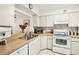 Bright kitchen with updated countertops, efficient appliances, and an open layout to the dining area at 1800 Mariner Dr # 9, Tarpon Springs, FL 34689