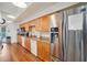 Community kitchen with stainless steel refrigerator, dishwasher, microwave, and coffee maker alongside wooden cabinets and granite counters at 1800 Mariner Dr # 9, Tarpon Springs, FL 34689