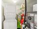 Convenient laundry room with stacked washer and dryer and a modern, efficient water heater system at 1800 Mariner Dr # 9, Tarpon Springs, FL 34689